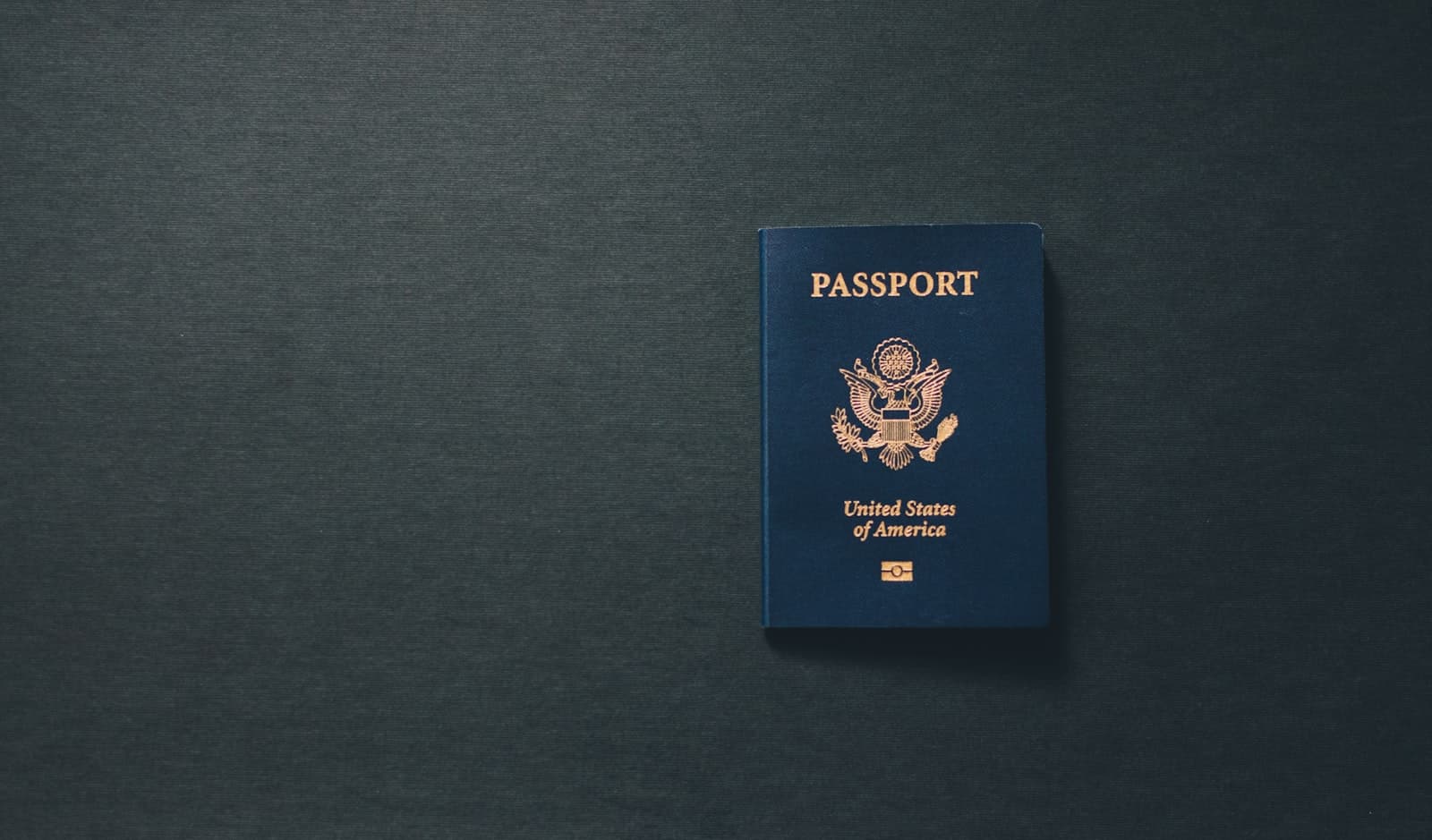 US passport on dark background — American expatriates and overseas nationals planning estates internationally
