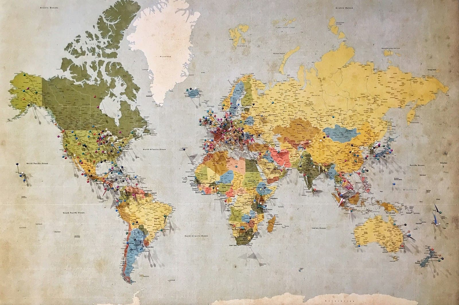 World map covered in colorful pins marking international locations — foreign financial accounts and FBAR reporting
