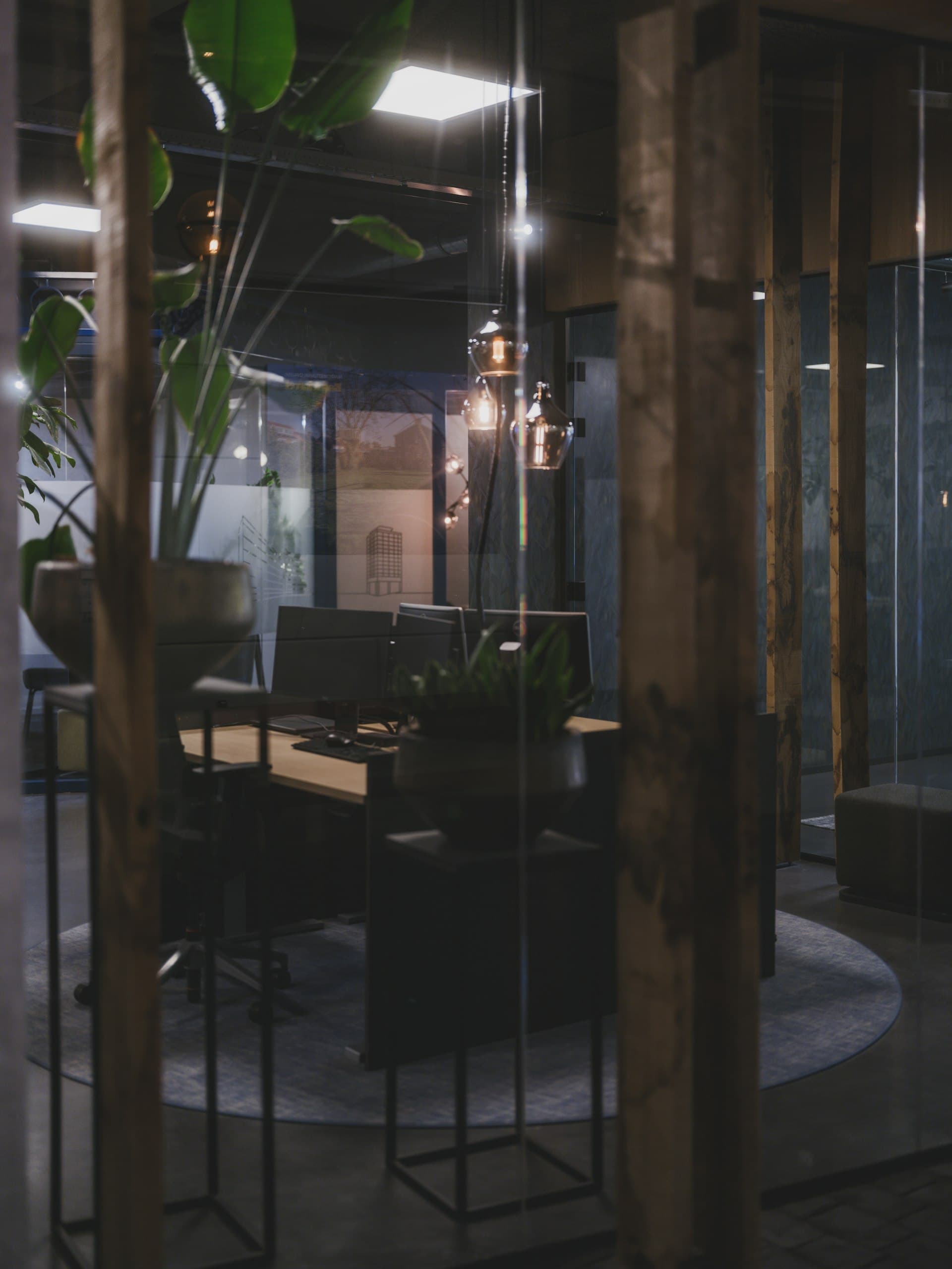 Premium law firm office interior with dark timber accents and warm Edison bulb lighting at the Houston Heights office